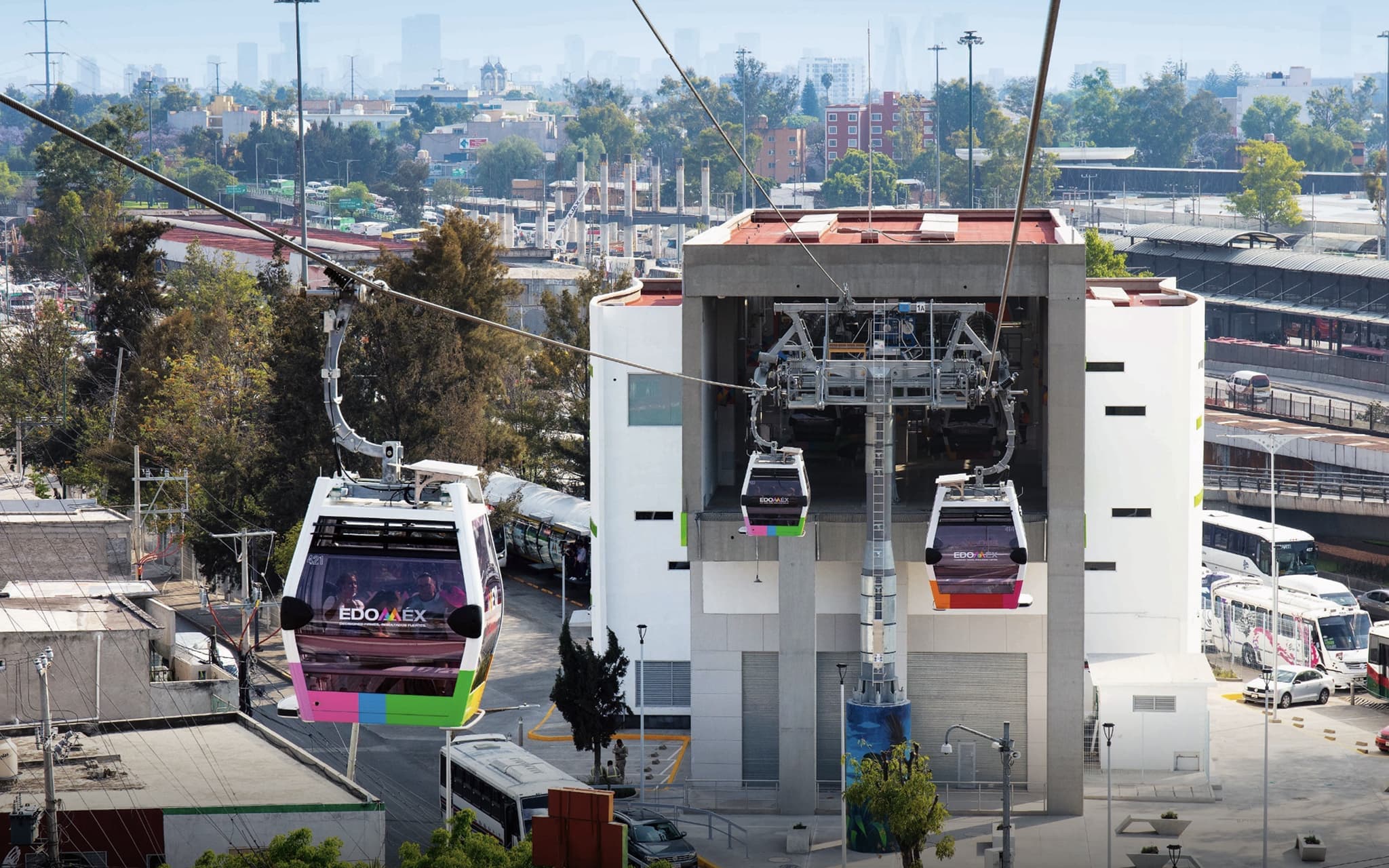 Gondola station with city buildings in the background